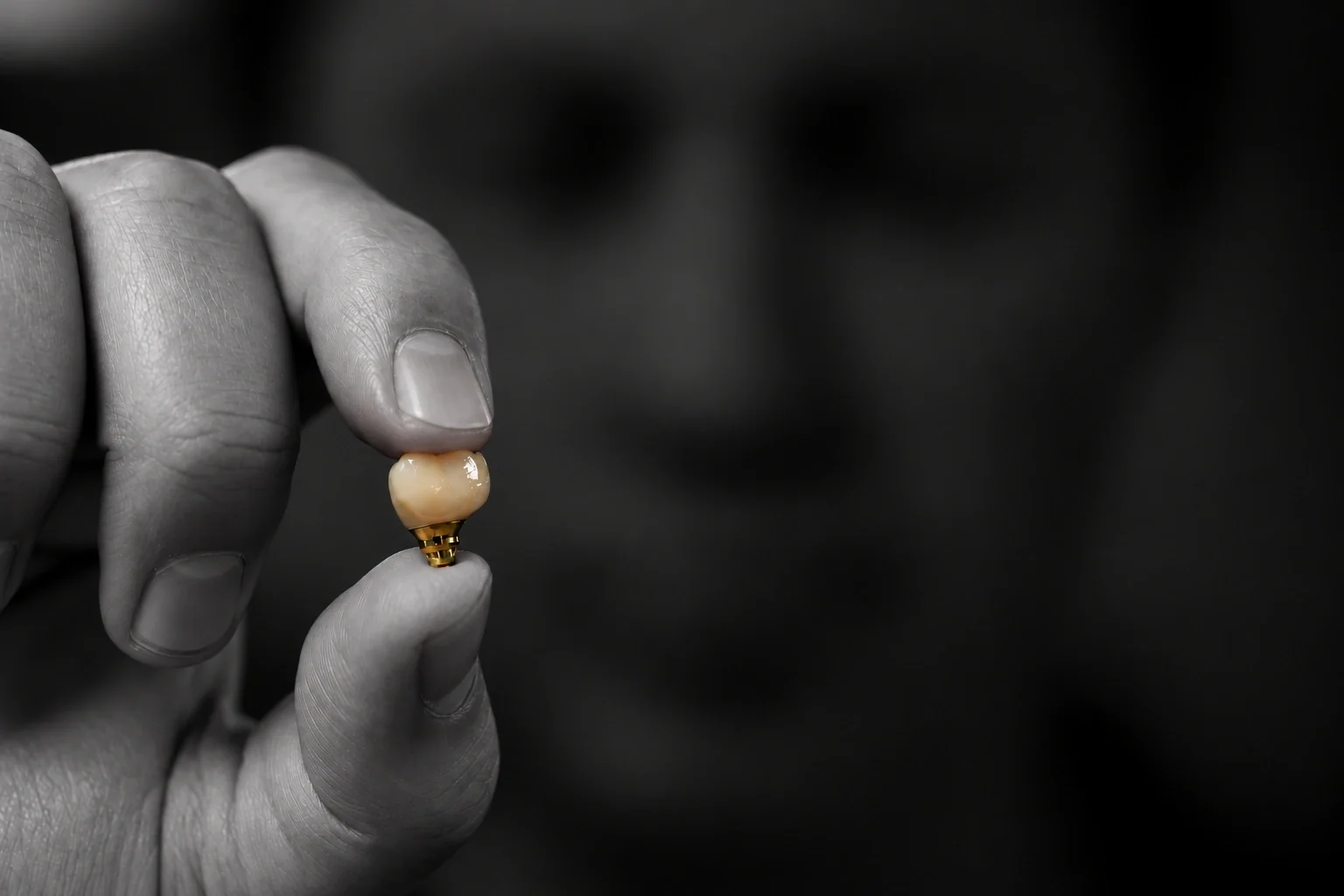 Technician holding a zirconia crown on a custom implant abutment